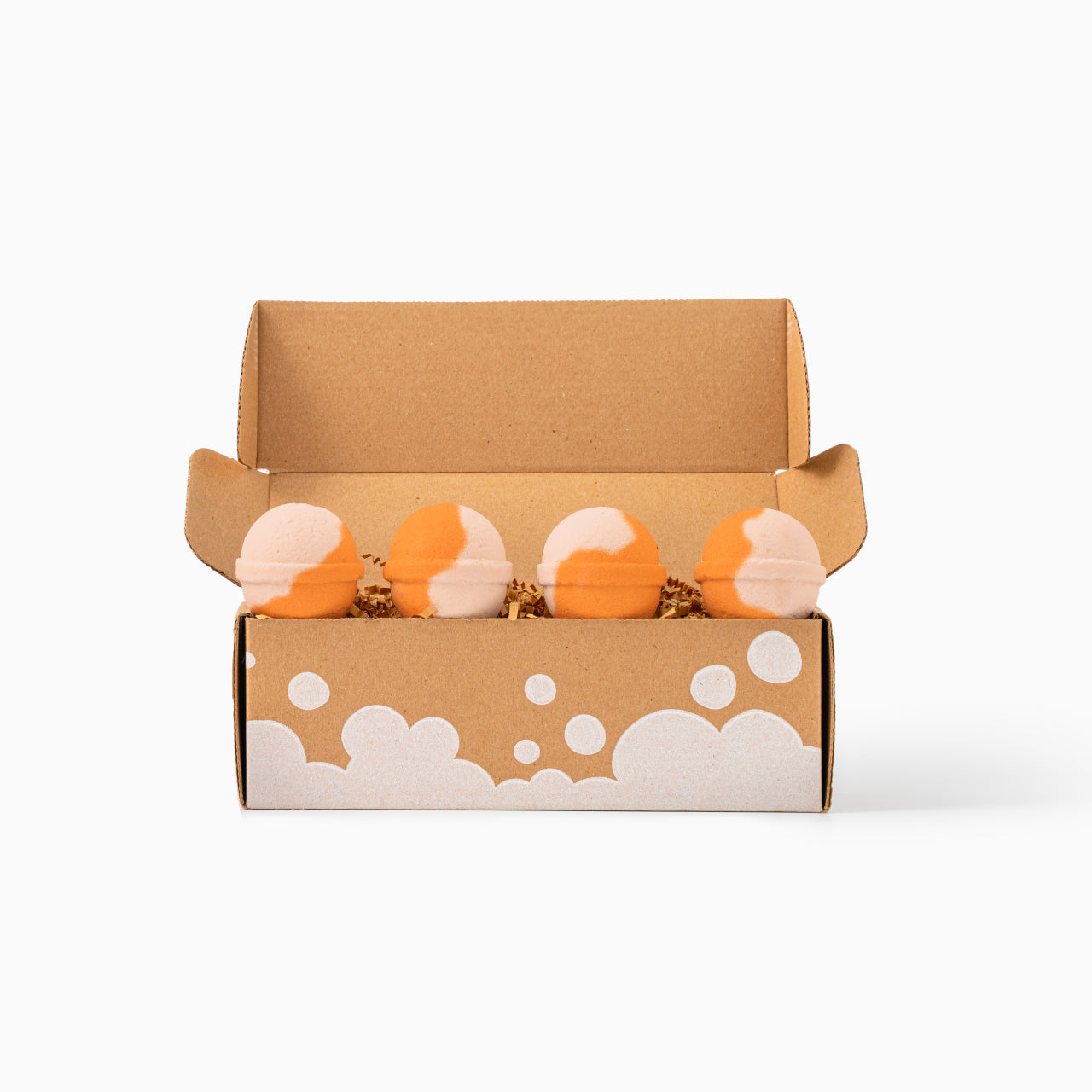 Open cardboard box with cloud design containing four bath bombs on a white background